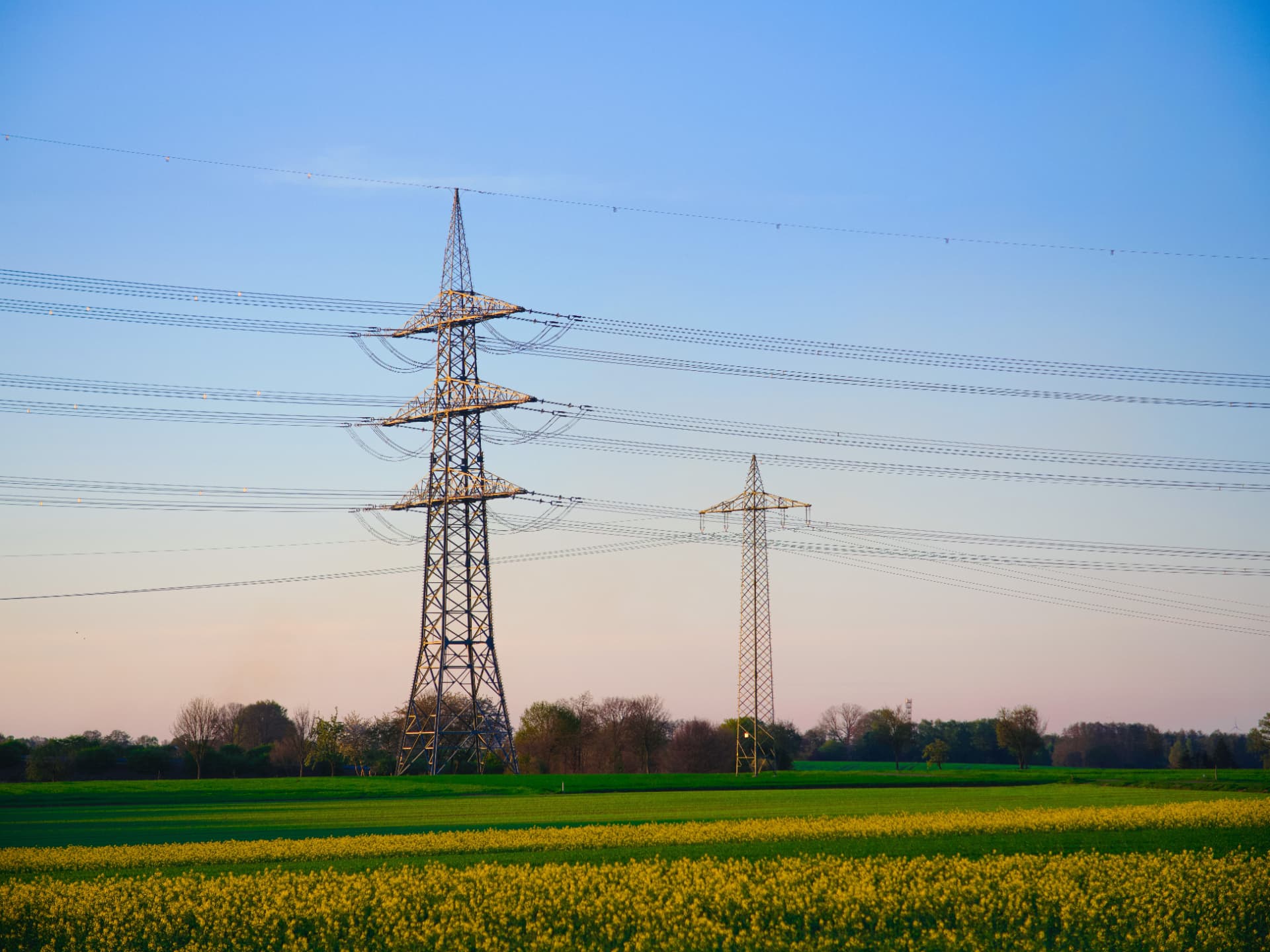 Transmission pylons carrying power across open farmland